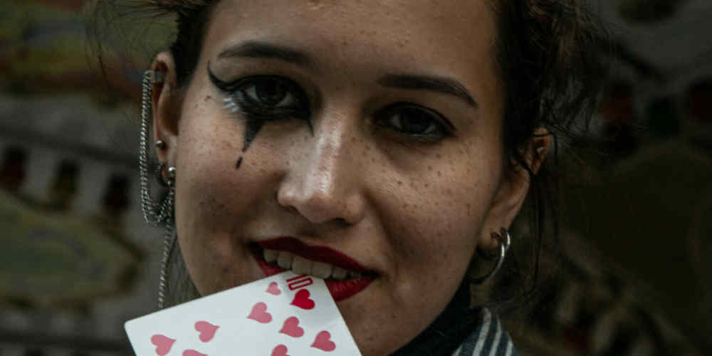 women biting a playing card