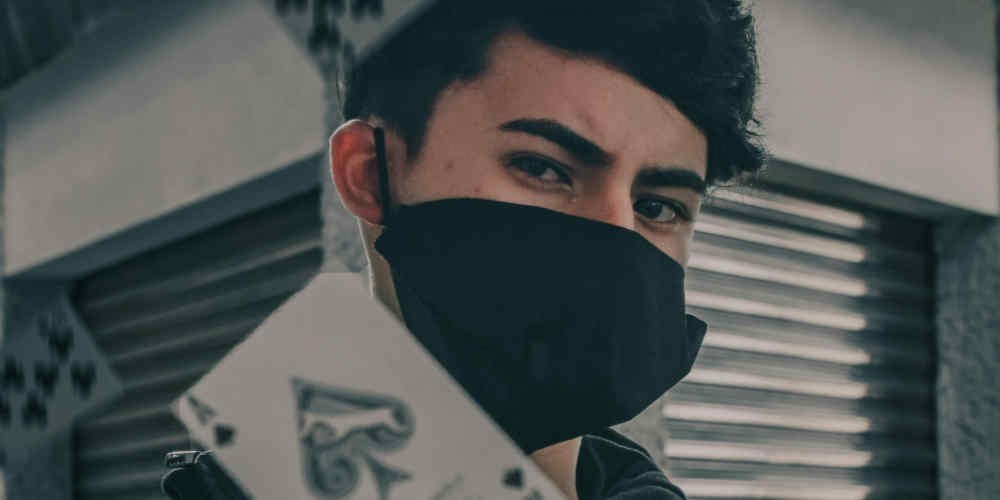 personality types and casino games mood image with covered face and playing cards