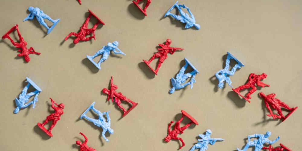 Ethics of Betting on the Iran-US War displayed with fallen toy soldiers